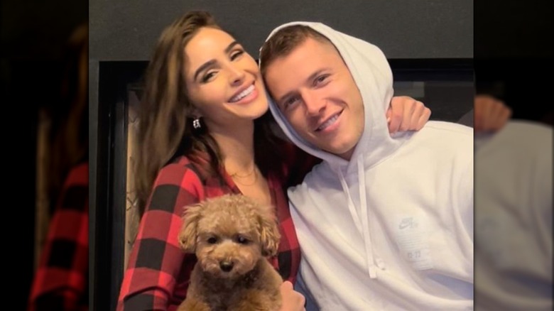 Christian McCaffrey and Olivia Culpo with a dog