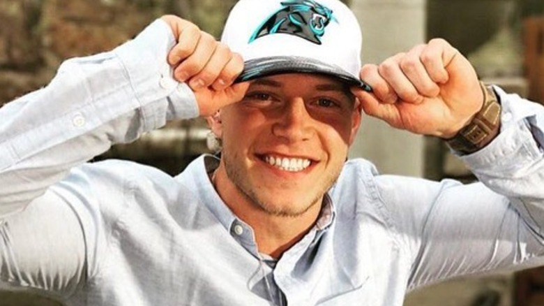 Christian McCaffrey smiling baseball cap