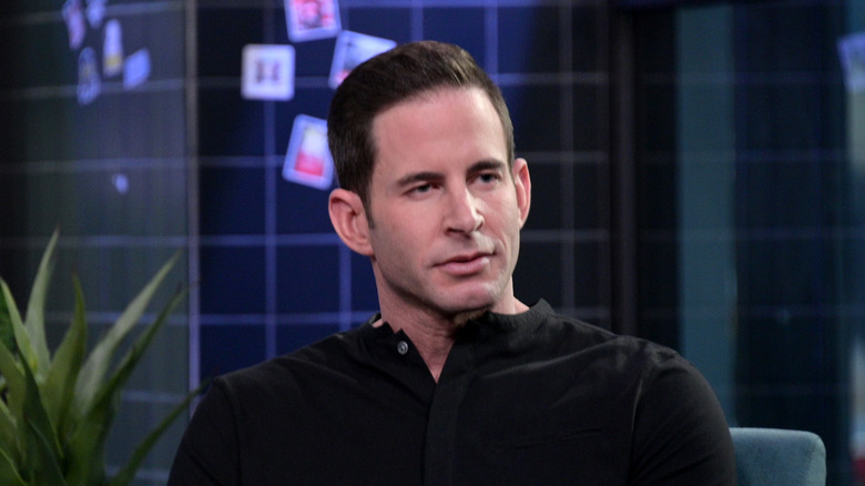 Tarek El Moussa sits looking to the side