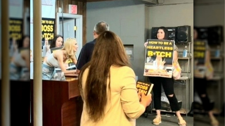 Christine Quinn and PETA protester at signing