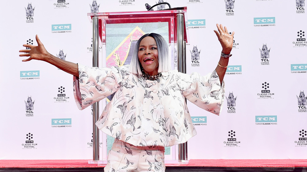 Cicely Tyson waves her hands in the air after her handprint ceremony 