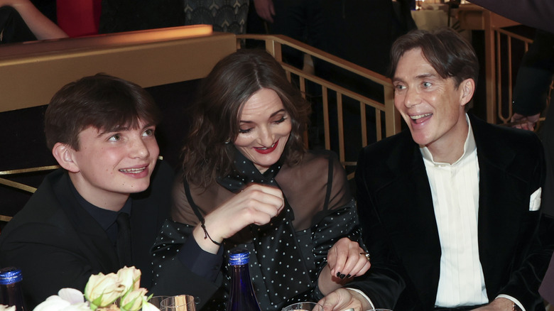 Aran Murphy, Yvonne McGuinness, and Cillian Murphy sit at table laughing