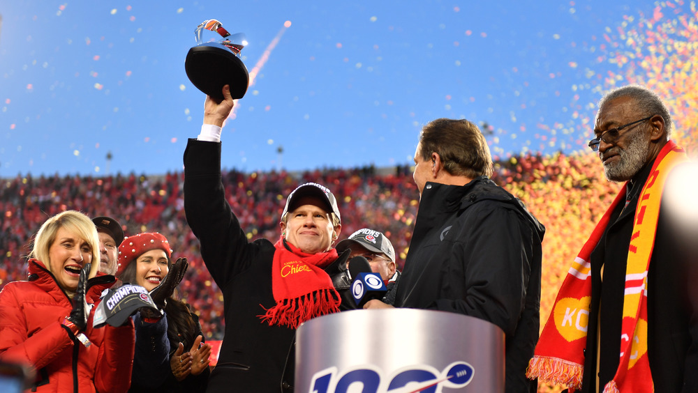 Clark Hunt holding a trophy at the Super Bowl