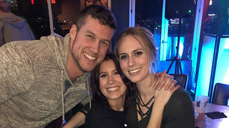 Clayton Echard posing with two women