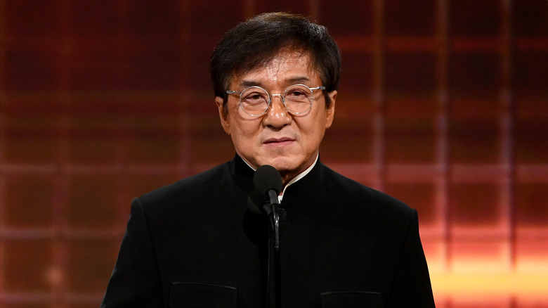 Jackie Chan speaking into microphone