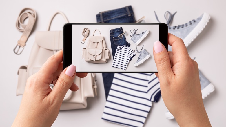 Woman taking photos of clothing