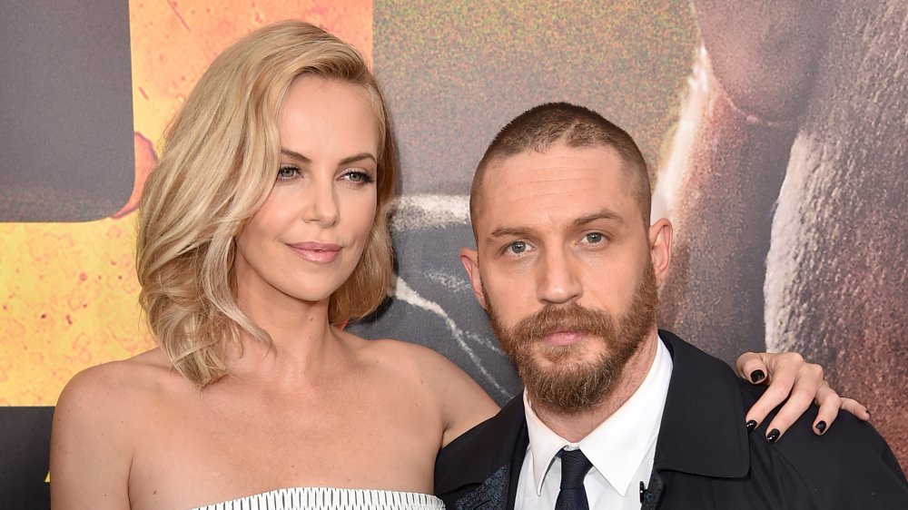 Charlize Theron and Tom Hardy arm in arm 