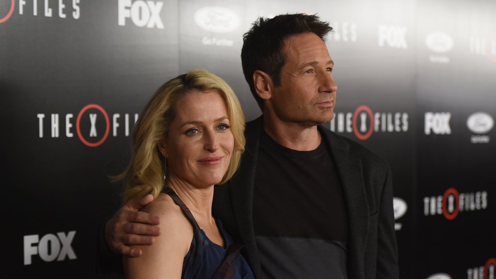 Gillian Anderson with David Duchovny's hand around her
