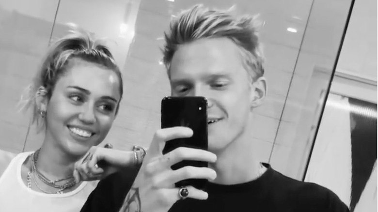 Miley Cyrus and Cody Simpson smiling for selfie