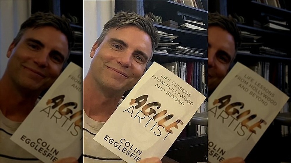 Colin Egglesfield holding his book, Agile Artist