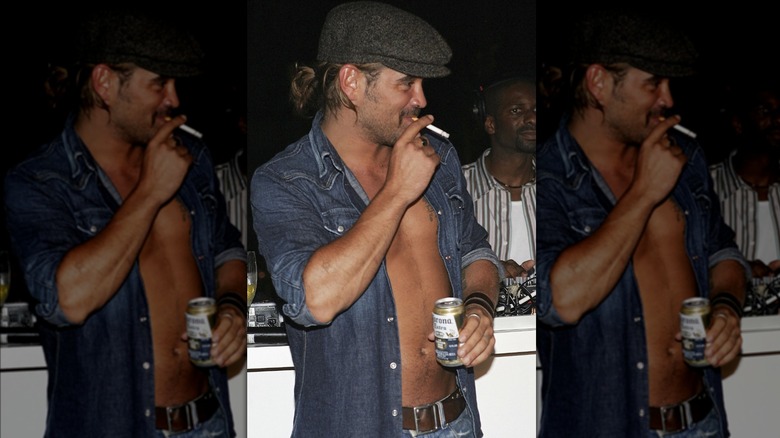 Colin Farrell smoking a cigarette and drinking a beer