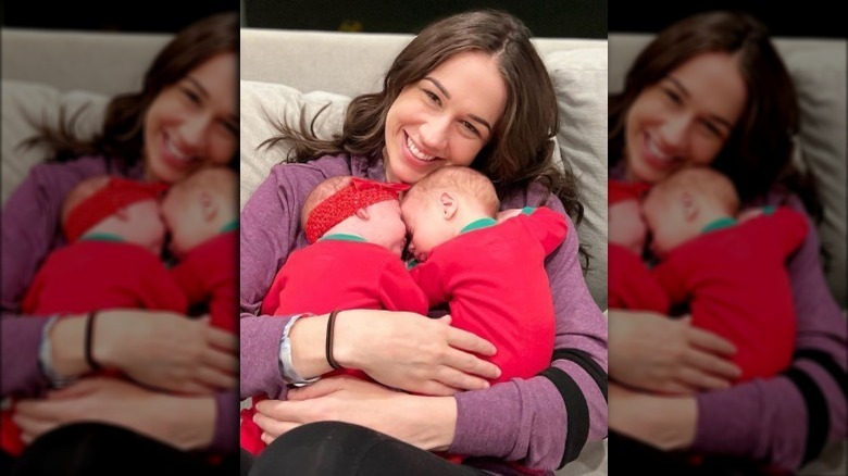 Colleen Ballinger smiling holding twins Maisy and Wesley