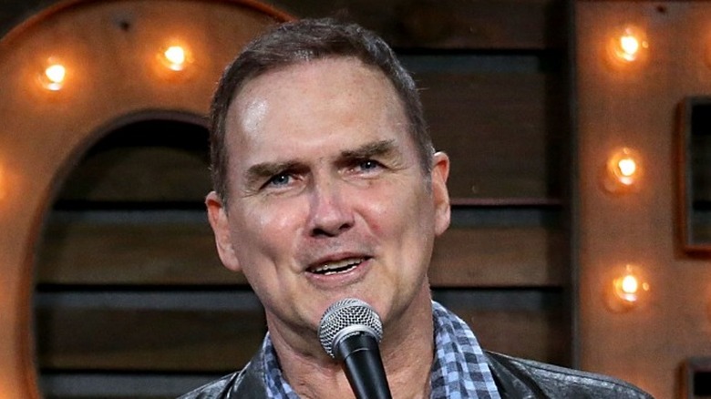 Norm Macdonald talking into mic 