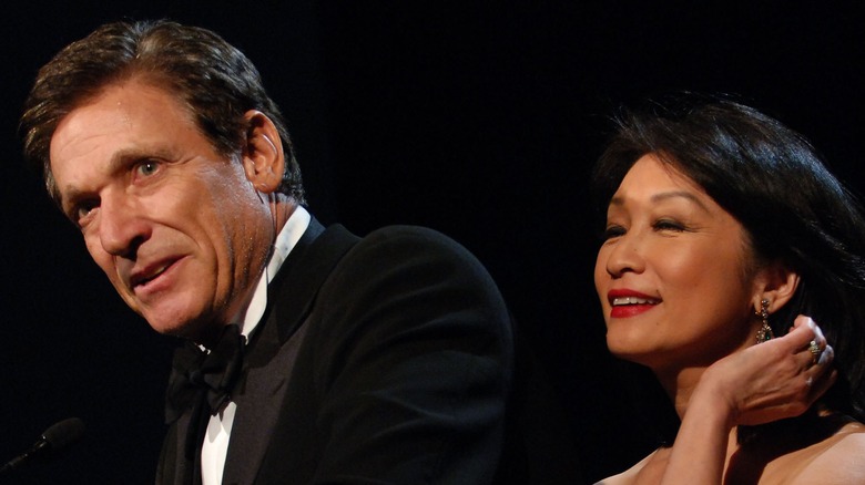 Maury Povich and Connie Chung staring away from camera at award show