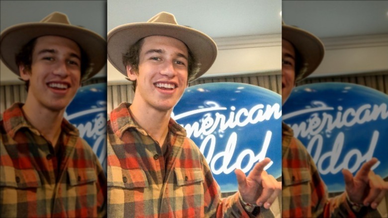 Wyatt Pike posing in front of the American Idol logo