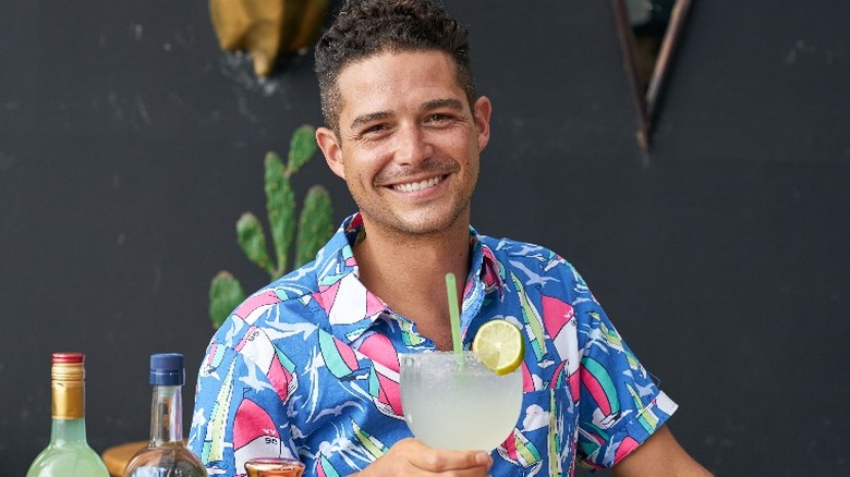 Wells Adams holding a drink