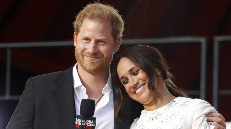 Prince Harry giving Meghan Markle a side hug