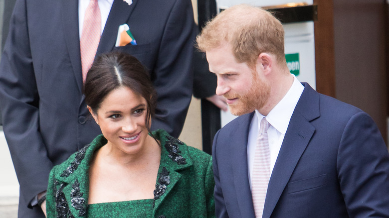 Meghan Markle and Prince Harry looking toward one another 