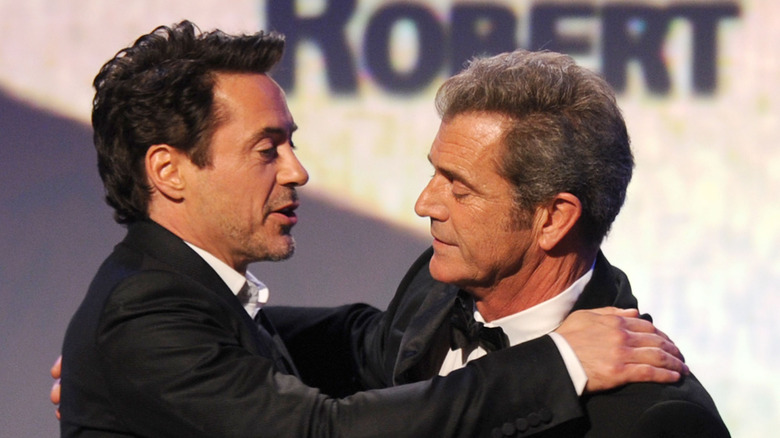 Robert Downey Jr. and Mel Gibson embracing