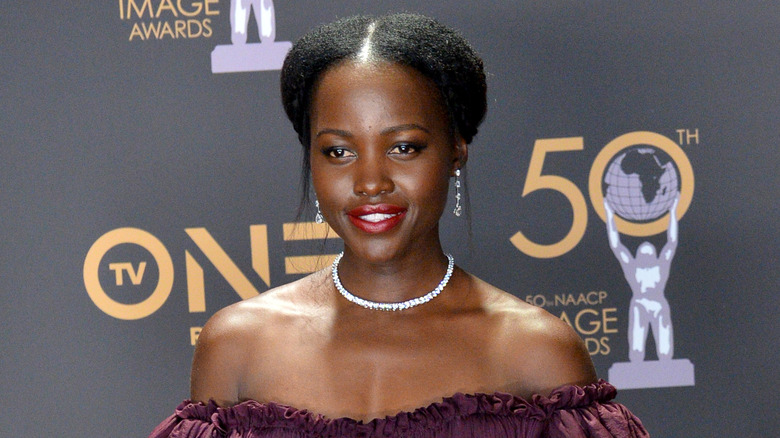 Lupita Nyong'o posing on a red carpet