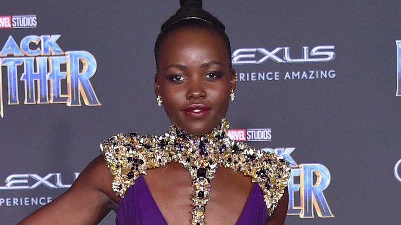 Lupita Nyong'o poses on a red carpet