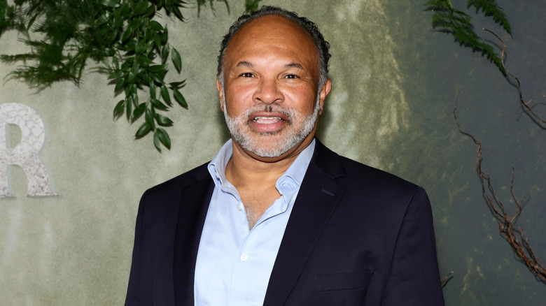 Geoffrey Owens smiling in light blue shirt and dark blue blazer