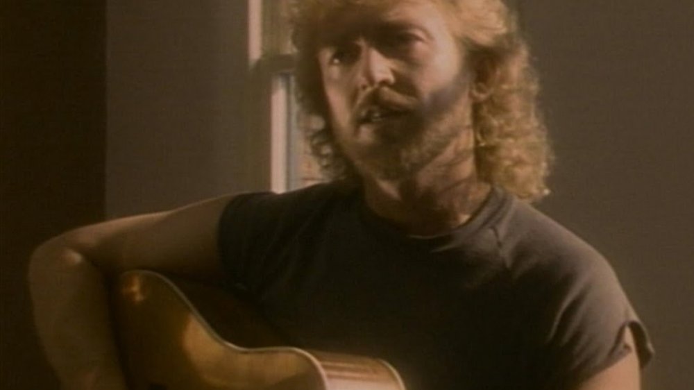 Keith Whitley singing with his guitar 