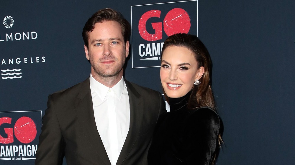 Armie Hammer and Elizabeth Chambers posing arm in arm