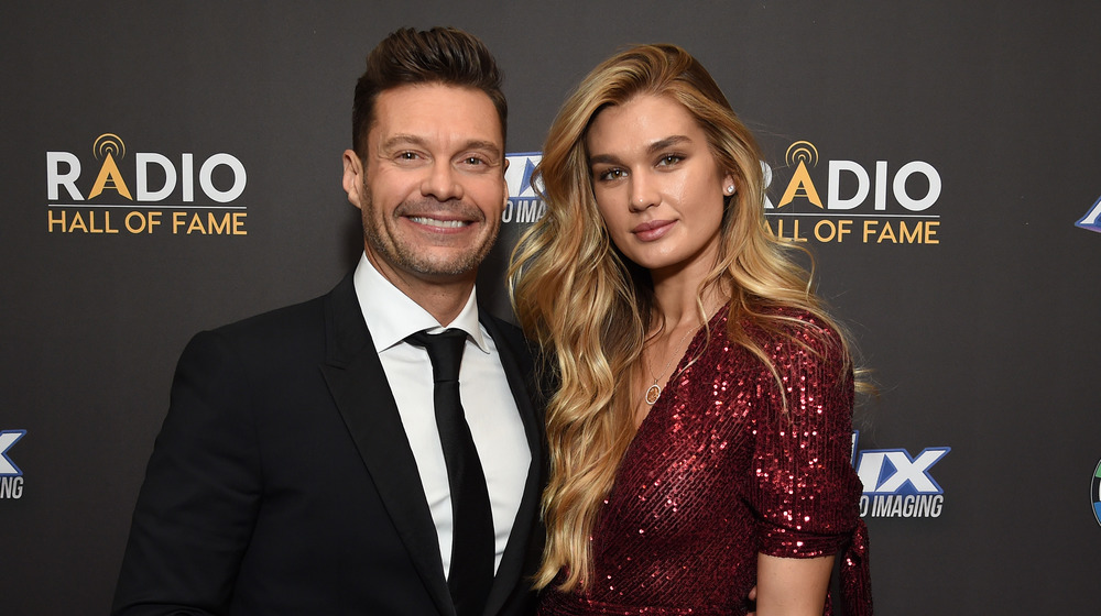 Ryan Seacrest and Shayna Taylor posing arm in arm