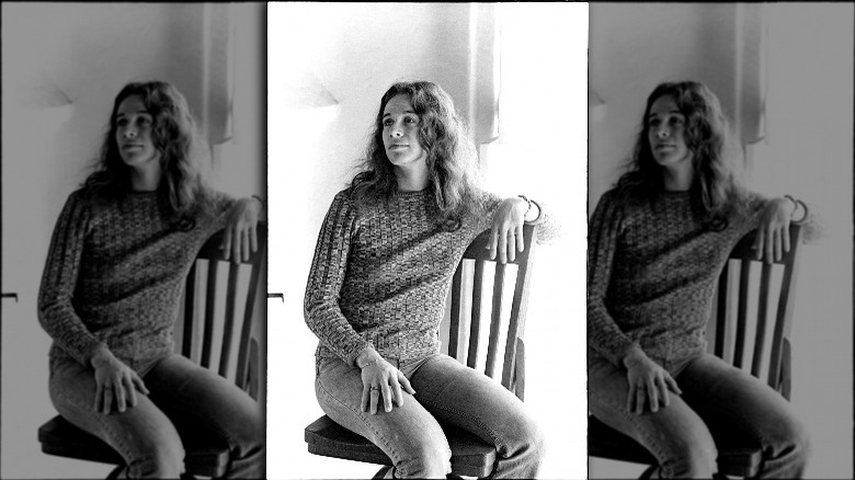 Carole King sitting in a chair in the Laurel Canyon home