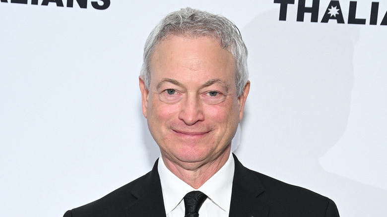 Gary Sinise smiles in close-up on red carpet 