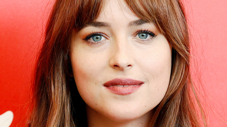 Dakota Johnson smiles on the red carpet