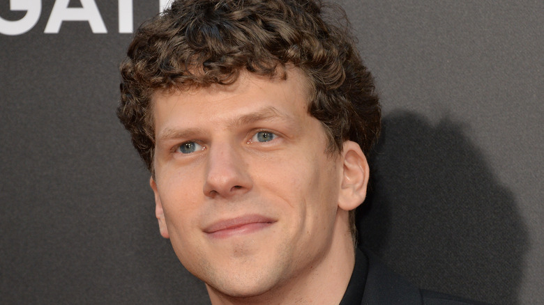 Jesse Eisenberg smiles on the red carpet