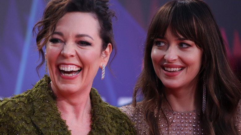 Olivia Colman and Dakota Johnson laughing 