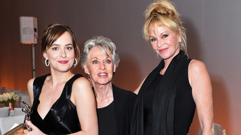 Dakota Johnson, Tippi Hedren, and Melanie Griffith pose together