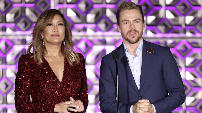 Carrie Ann Inaba and Derek Hough posing on stage