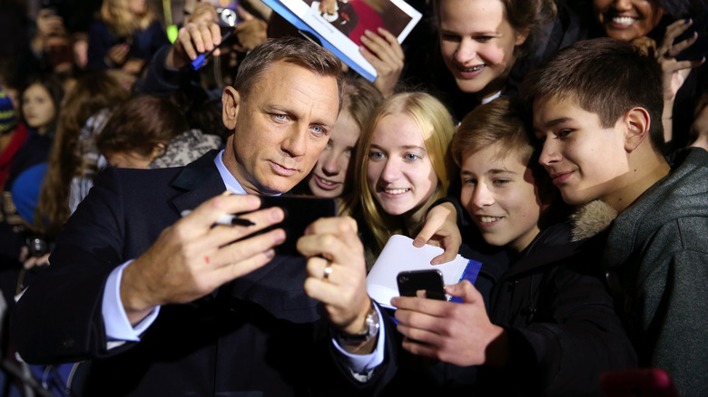 Daniel Craig posing with fans