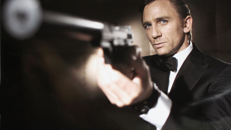 Daniel Craig as Bond holding gun