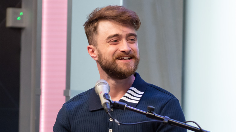 Daniel Radcliffe speaking into a microphone