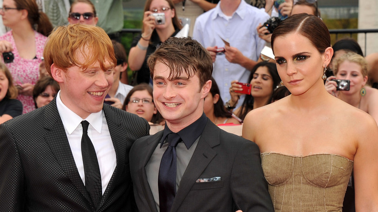 Rupert Grint, Daniel Radcliffe, and Emma Watson posing