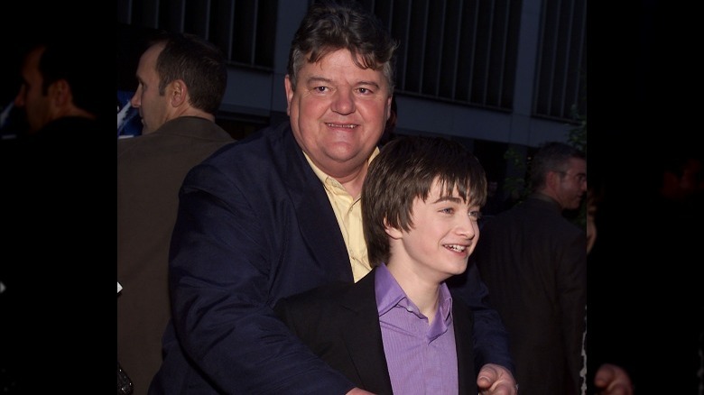 Robbie Coltrane and young Daniel Radcliffe posing