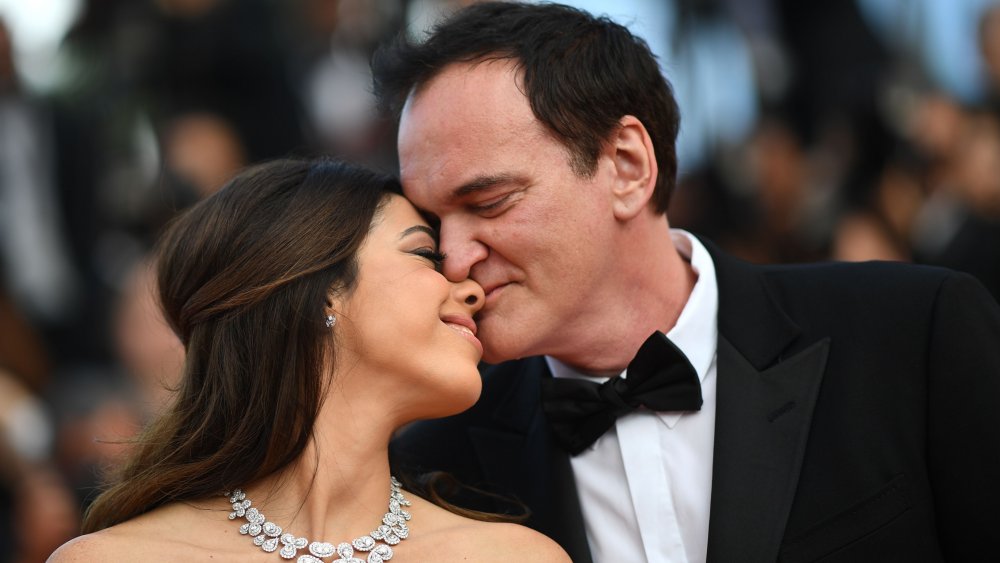 Quentin Tarantino (R) kisses his wife Israeli singer Daniella Pick at the 72nd edition of the Cannes Film Festival