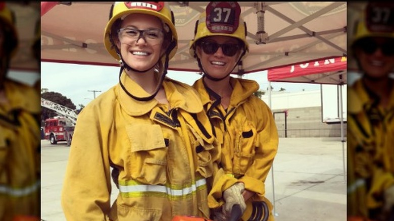 Danielle Savre and Stephanie Savre dressed in firefighter uniforms 