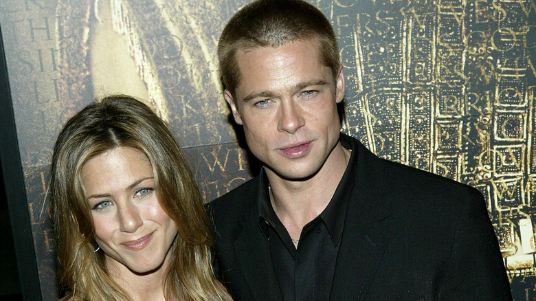 Jennifer Aniston and Brad Pitt posing