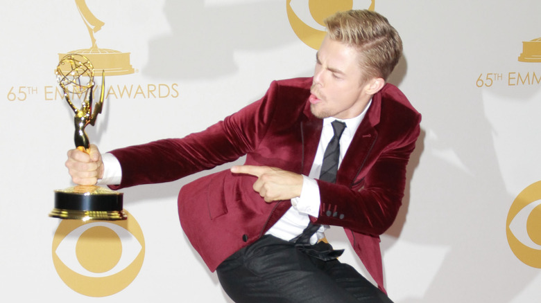 Derek Hough pointing at Emmy