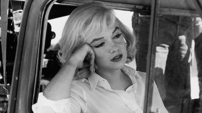 Marilyn Monroe staring out a car window