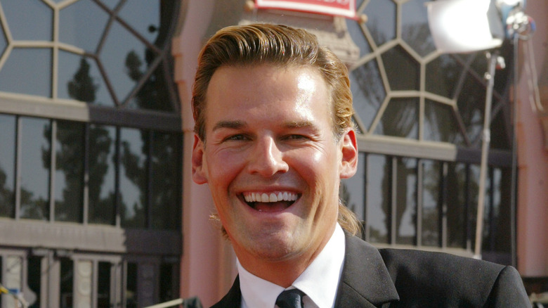 Brian Heidik smiling in a suit