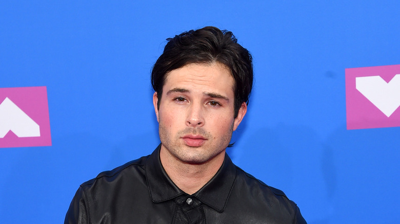 Cody Longo on a red carpet, posing