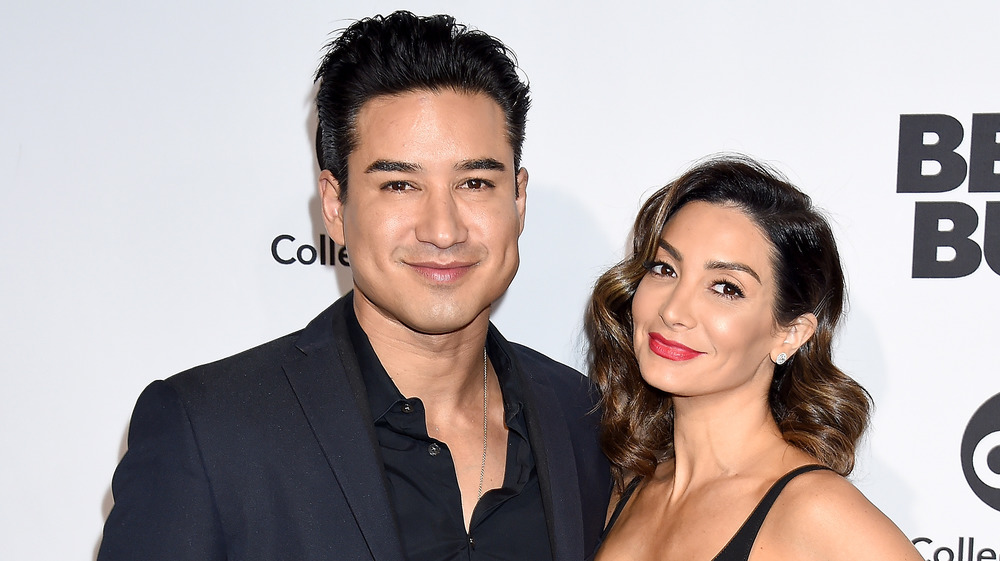 Mario Lopez posing on the red carpet with his wife Courtney Laine Mazza