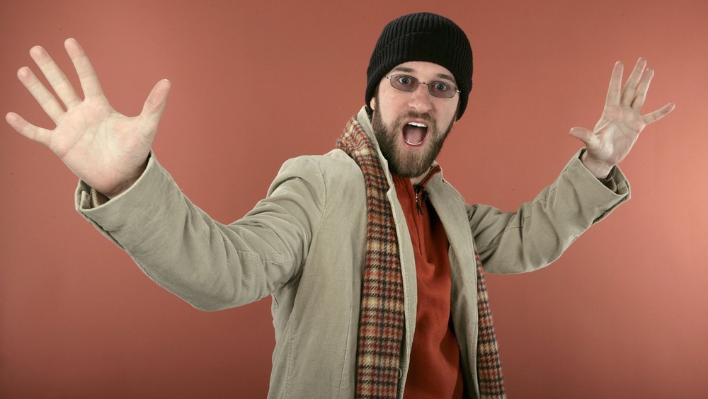 Dustin Diamond with his hands in the air and mouth open 